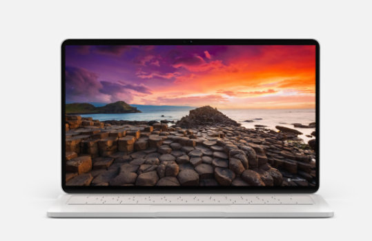 A laptop displaying a colorful seascape from Bing Wallpaper.